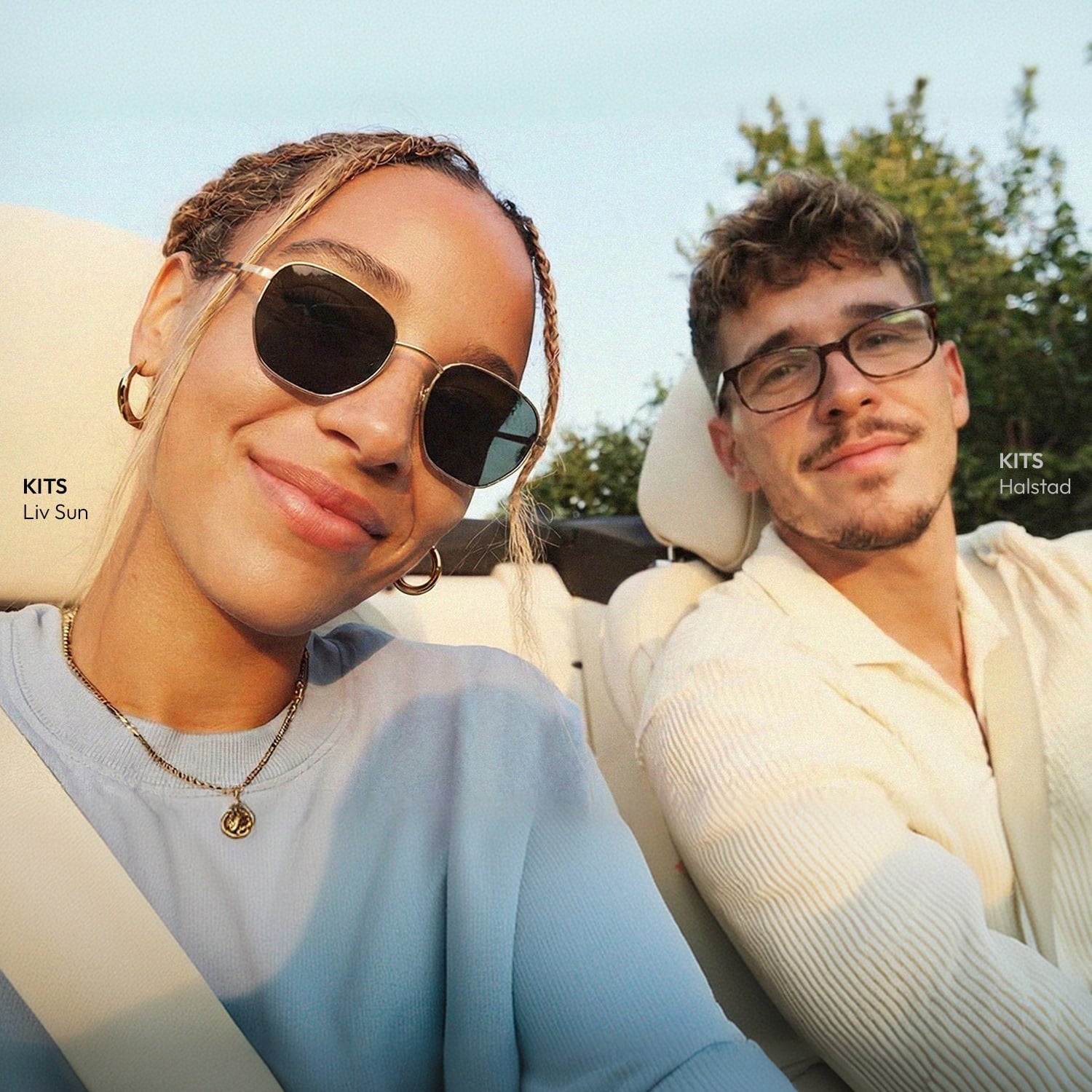 Two people wearing KITS summer eyewear in a car