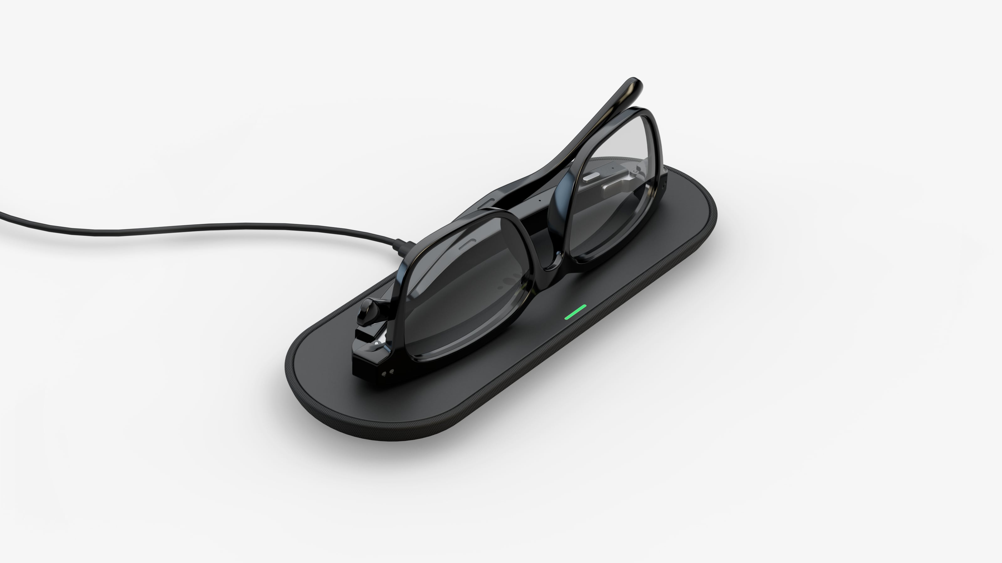 Nuance Audio hearing glasses resting on wireless charging pad